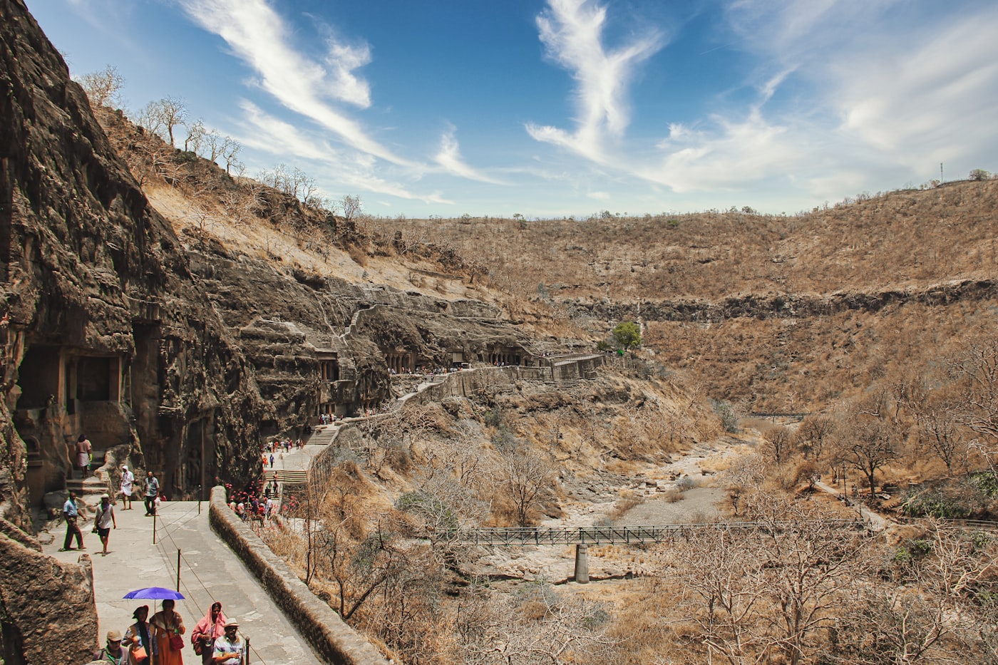 Rock-cut Ajanta caves set into a sweeping green valley